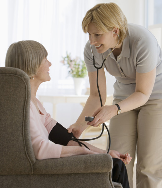 Senior woman having blood pressure taken.