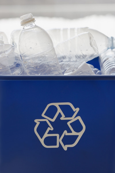 Recycle bin filled with bottles.