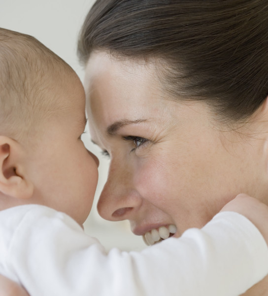 Mother smiling at baby.