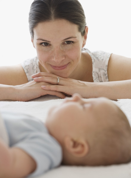 Mother watching baby sleep.