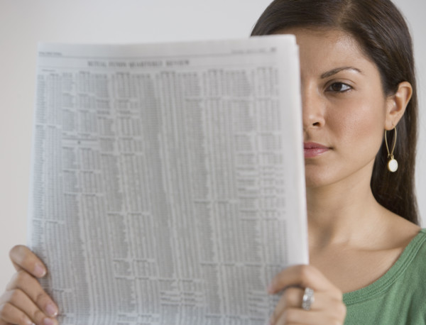Indian woman reading newspaper.
