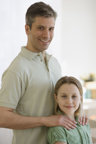 Father with hands on daughter’s shoulders.