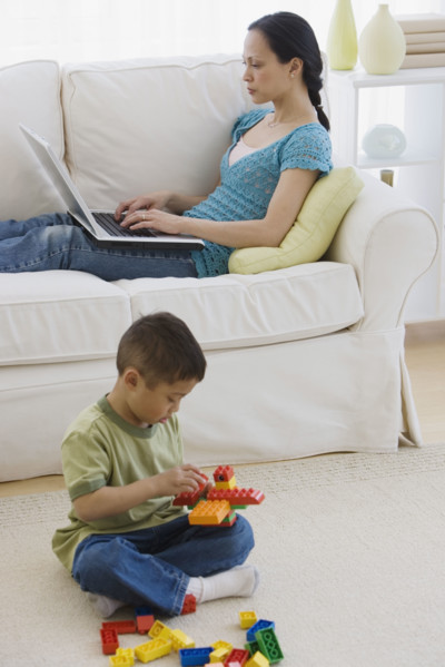 Asian mother and son relaxing in livingroom.