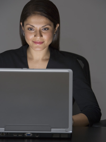 Indian businesswoman looking at laptop.