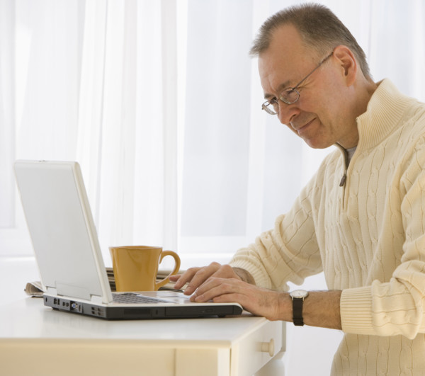 Man typing on laptop.
