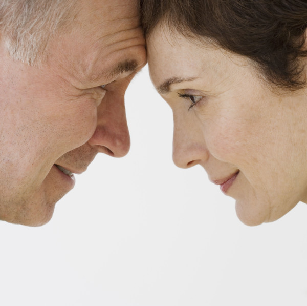 Close up of couple touching foreheads.