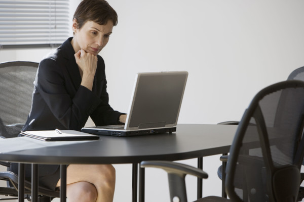 Businesswoman looking at laptop.
