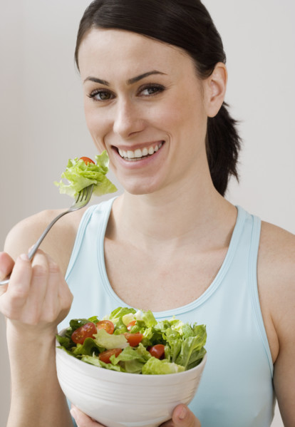 Portrait of woman eating salad.