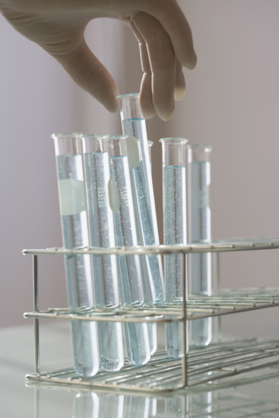Scientist taking vial out of rack.