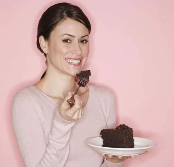 Portrait of woman eating cake.
