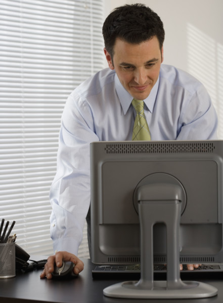 Businessman typing on computer.