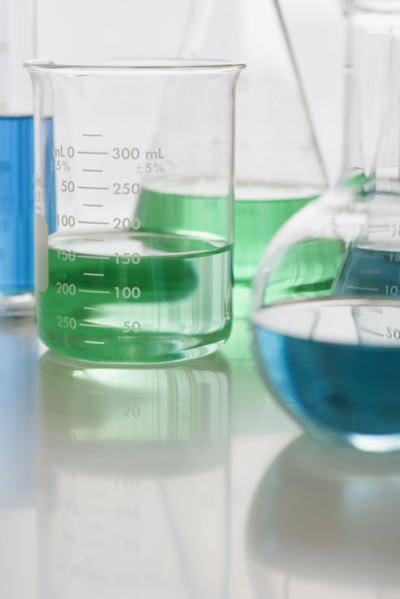 Close up of beakers with liquid.