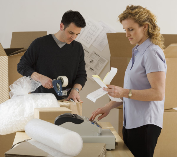Businesspeople packing boxes.