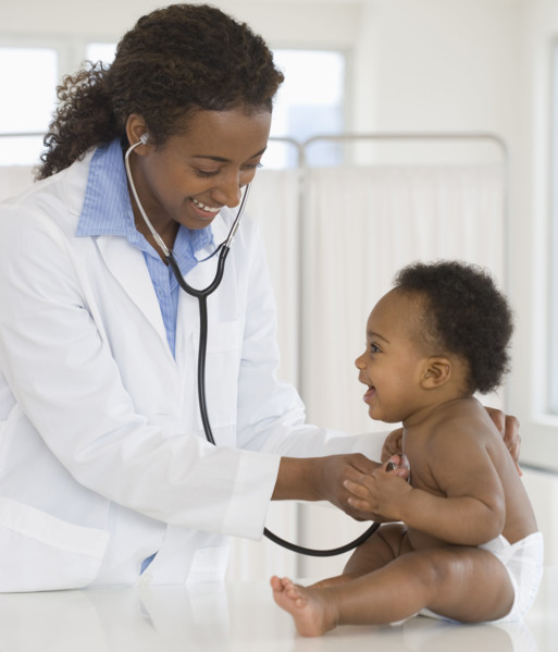 Female doctor examining baby.