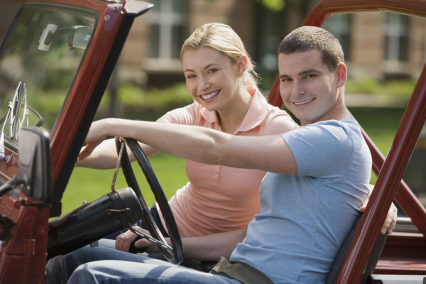 Couple sitting in jeep.