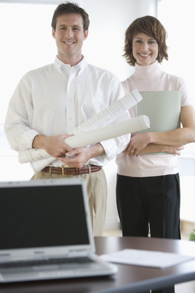 Portrait of businesspeople with blueprints.