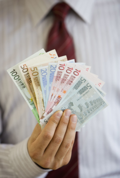 Businessman holding Euro banknotes.