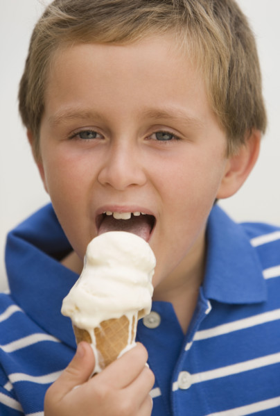 Boy eating ice cream cone.