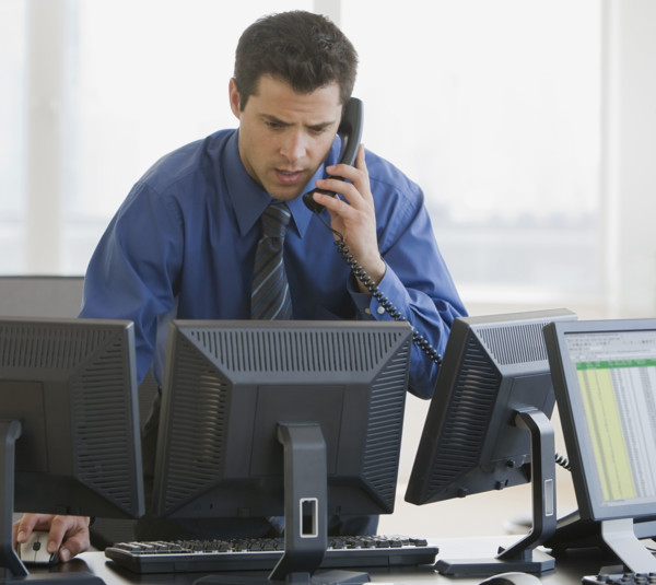 Businessman talking on telephone.