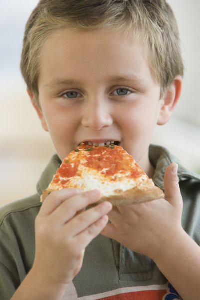 Boy eating pizza.