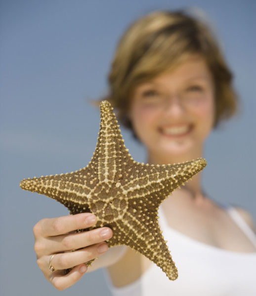 Woman holding starfish.