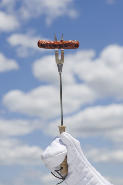 Hot dog on barbeque fork.