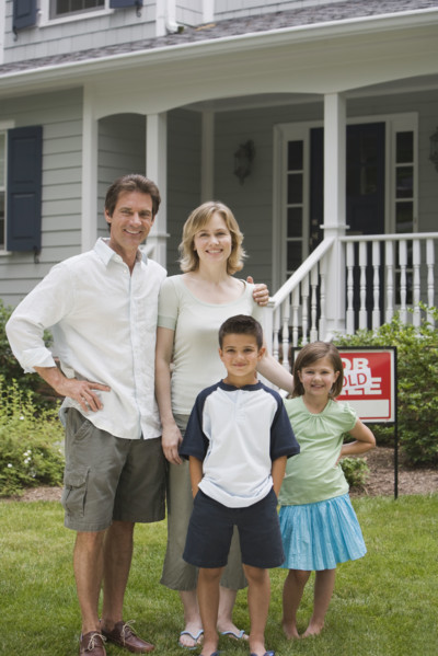Family in front of new house.