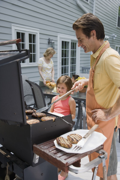 Family barbequing on deck.