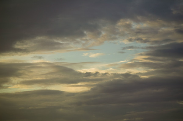 Sun shining through cloudy sky.