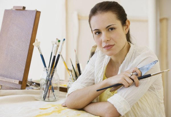 Female artist in painting studio.