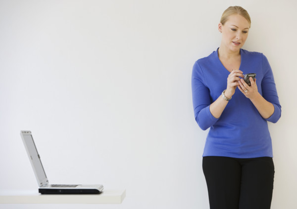 Businesswoman using electronic organizer.