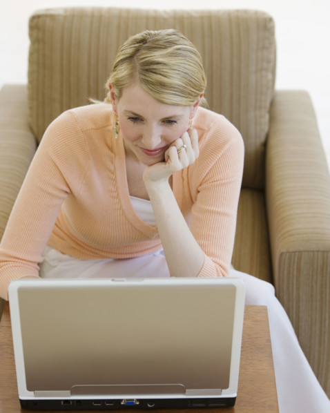 Woman looking at laptop.