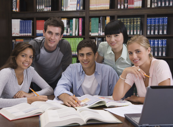 College students studying in library.