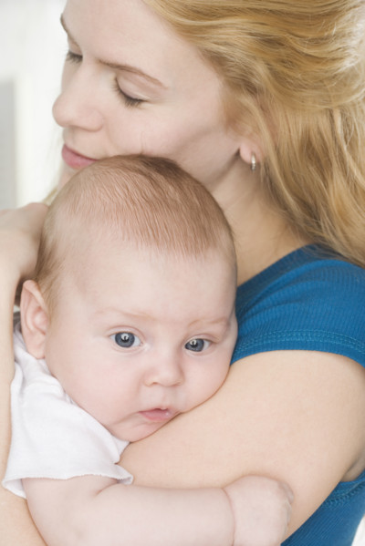 Mother hugging baby. Date : 2006