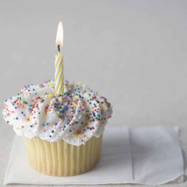 Cupcake with one candle and napkin. Date : 2006