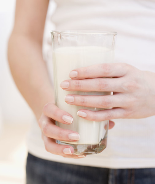 Woman holding glass of milk. Date : 2007
