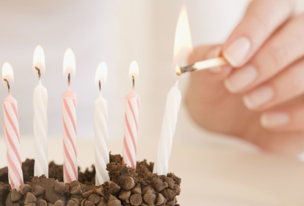 Woman lighting birthday candles. Date : 2007