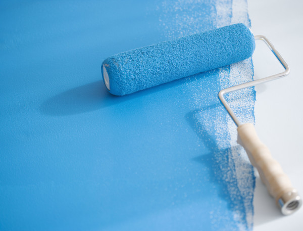 Paint roller on partially painted floor. Date : 2006