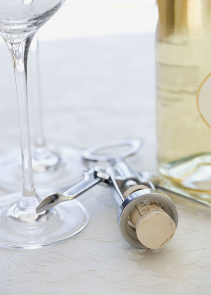 Close up of corkscrew and wine glasses. Date : 2006