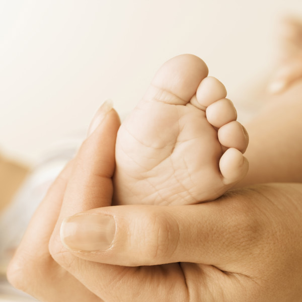 Close up of baby’s foot in mother’s hand. Date : 2006