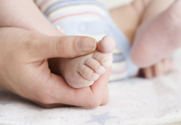 Close up of baby’s foot in mother’s hand. Date : 2006