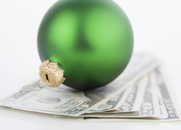 Studio shot of money and Christmas tree ornament. Date : 2006