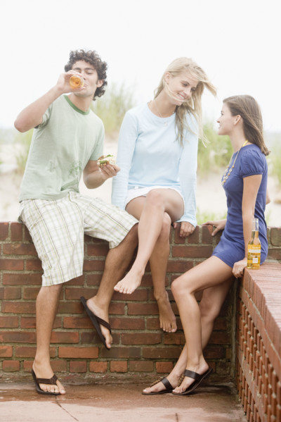 Friends leaning on brick wall. Date : 2007