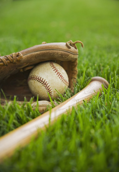 Baseball equipment laying on grass. Date : 2006