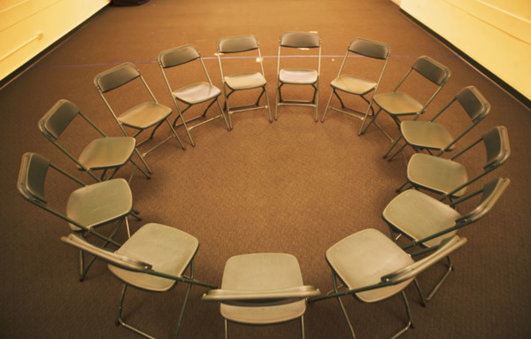 Empty folding chairs in circle. Date : 2007