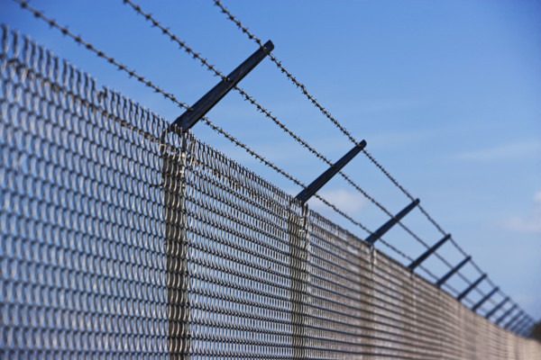 Metal fence with barbed wire. Date : 2007
