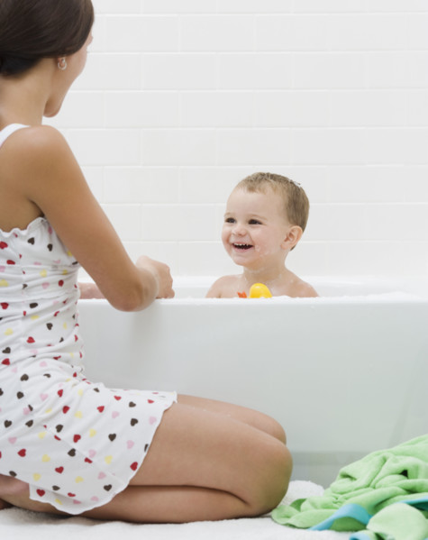 Mother giving baby a bath. Date : 2007