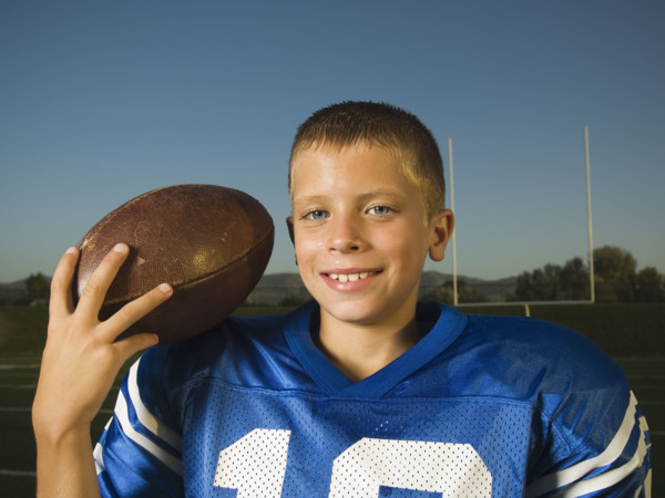 Young football player holding ball. Date : 2007