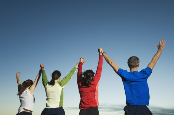 Rear view of people with arms raised, Salt Flats, Utah, United States. Date : 2007