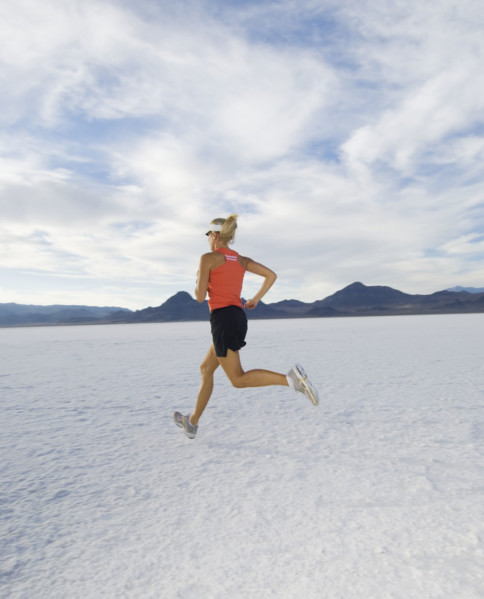 Woman running on salt flats, Utah, United States. Date : 2007